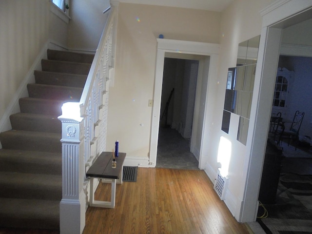 staircase with hardwood / wood-style flooring