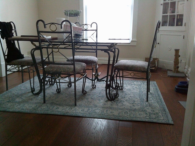 dining area with dark hardwood / wood-style floors