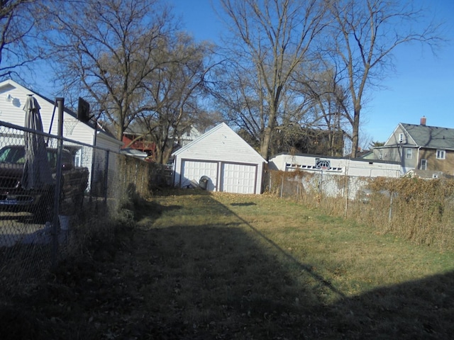 view of yard featuring a garage and an outdoor structure