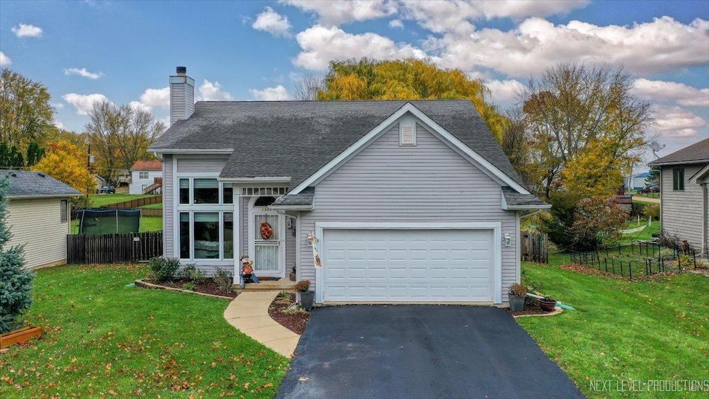 view of front of property with a garage and a front yard