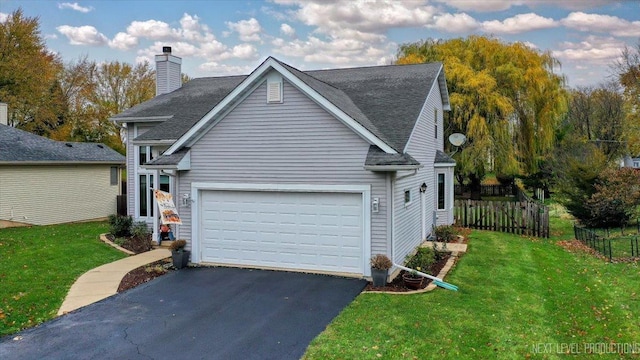 view of front of house with a garage and a front yard