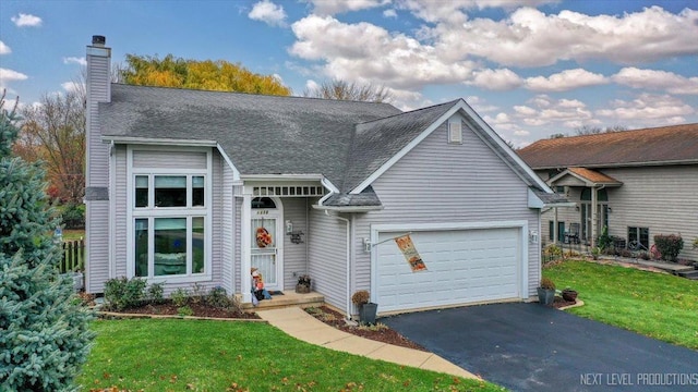 view of front facade with a garage and a front yard