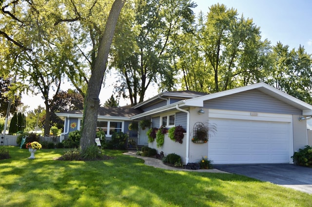 single story home featuring a garage, a front lawn, and aphalt driveway