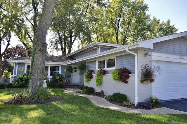 ranch-style house with an attached garage and a front lawn