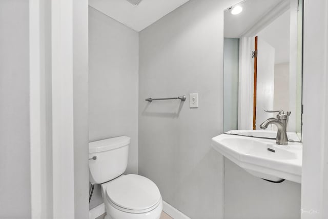 bathroom with toilet and sink