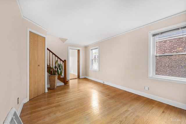 empty room featuring light hardwood / wood-style flooring and crown molding