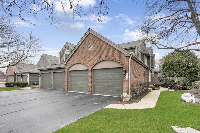 view of side of home with a garage and a yard