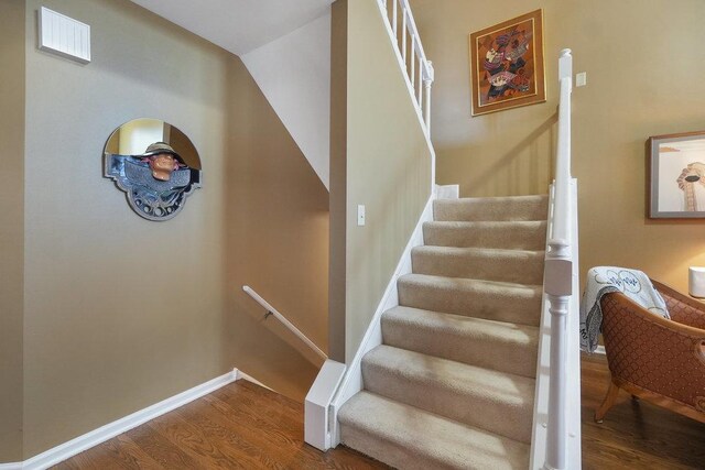 basement with a paneled ceiling, sink, and light carpet