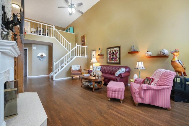 living room featuring a high ceiling, dark wood-type flooring, and ceiling fan