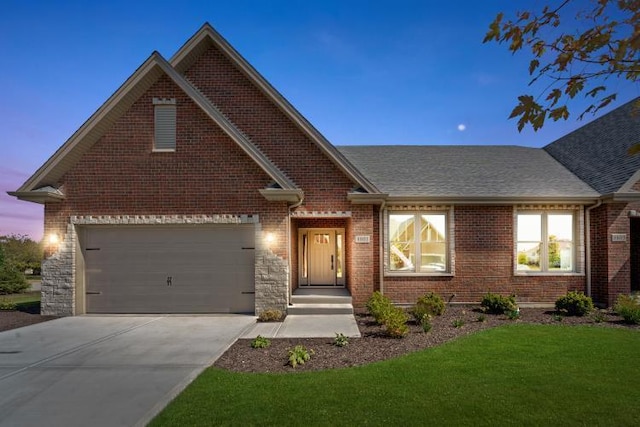 view of front of home with a lawn and a garage