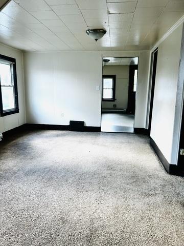 empty room featuring carpet floors and a healthy amount of sunlight