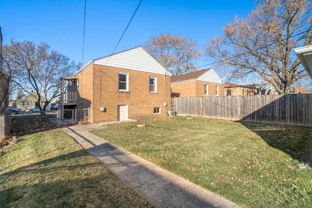 rear view of property featuring a lawn