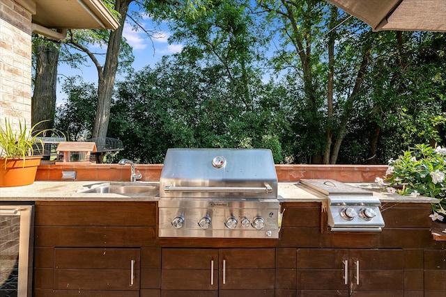 view of patio featuring sink, area for grilling, beverage cooler, and a grill