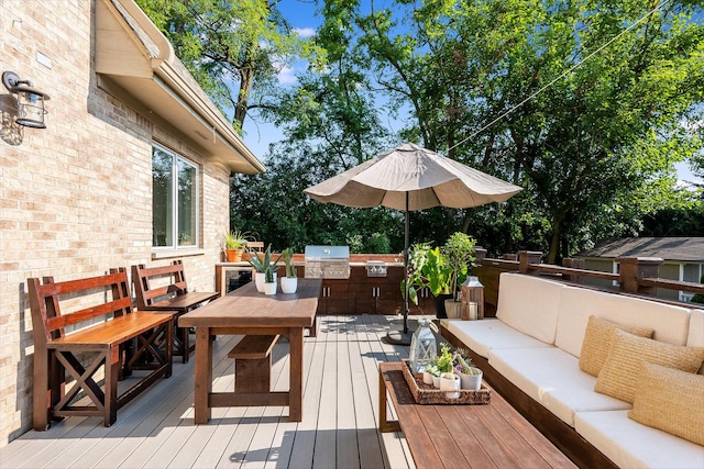 wooden terrace with area for grilling, an outdoor living space, and exterior kitchen