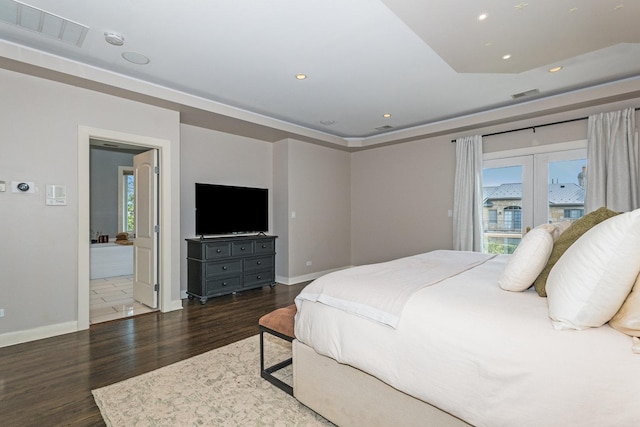 bedroom with dark hardwood / wood-style floors and connected bathroom