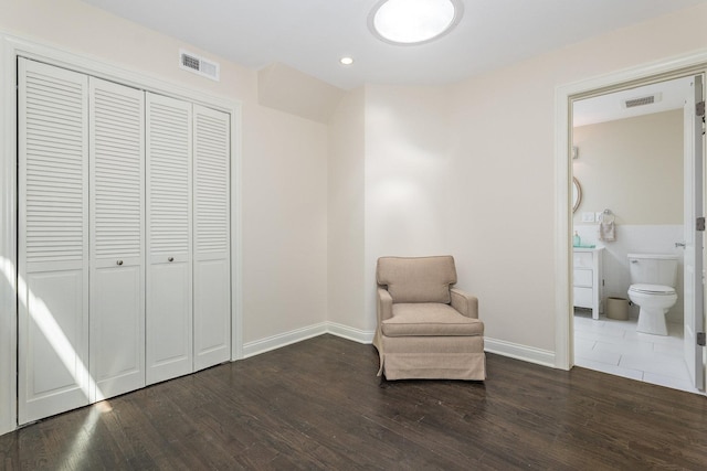 sitting room with dark wood-type flooring