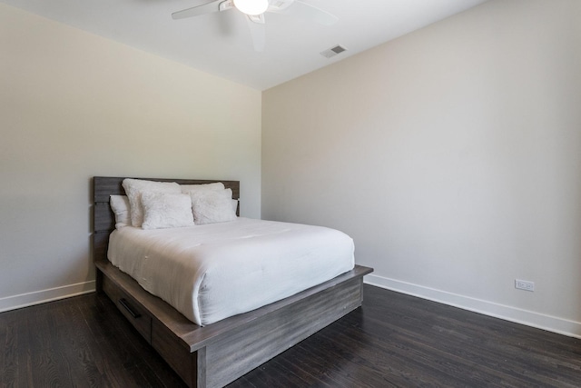 bedroom with ceiling fan and dark hardwood / wood-style flooring