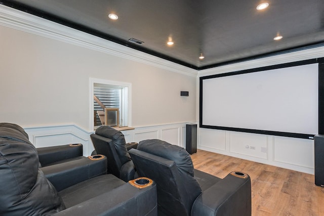 cinema featuring crown molding and light wood-type flooring