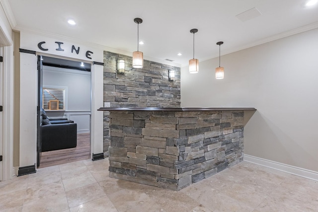 bar featuring pendant lighting and crown molding