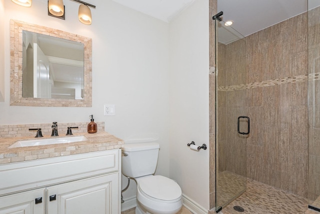 bathroom featuring vanity, an enclosed shower, and toilet