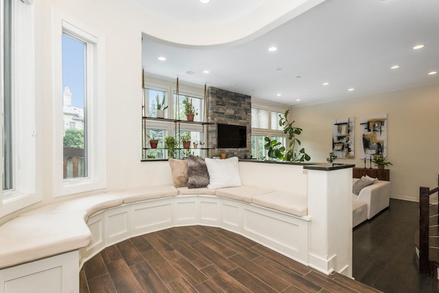 living room with plenty of natural light, dark hardwood / wood-style flooring, and crown molding