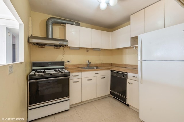 kitchen with butcher block countertops, white cabinetry, sink, and white appliances