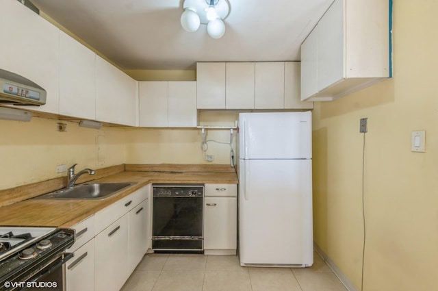 kitchen with sink, light tile patterned floors, white refrigerator, white cabinets, and black dishwasher