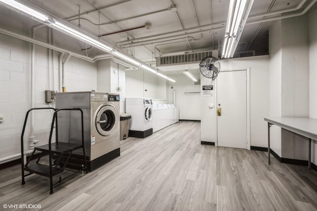 laundry area featuring light hardwood / wood-style flooring and washer and clothes dryer