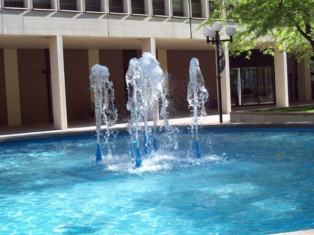 view of swimming pool featuring pool water feature