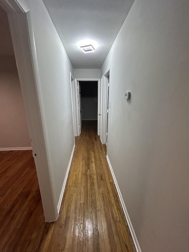 corridor featuring hardwood / wood-style floors