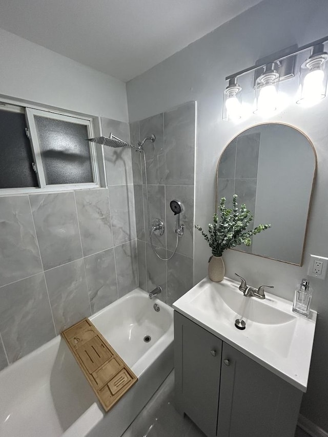 bathroom with vanity and tiled shower / bath