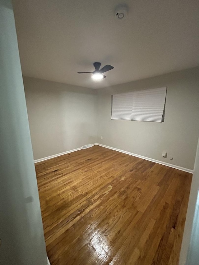 empty room with ceiling fan and wood-type flooring