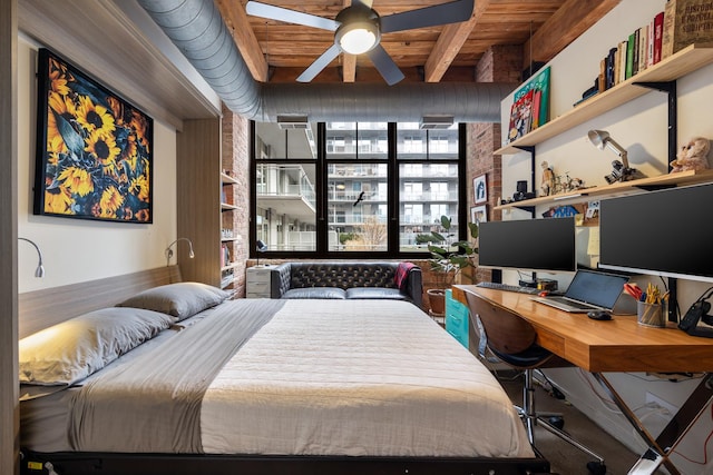 bedroom featuring beam ceiling, ceiling fan, wooden ceiling, and brick wall