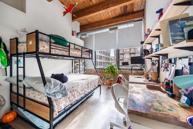 bedroom featuring beam ceiling, concrete floors, and wood ceiling