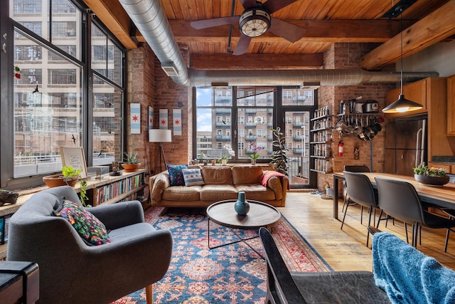 living room with hardwood / wood-style flooring, ceiling fan, beam ceiling, and wood ceiling