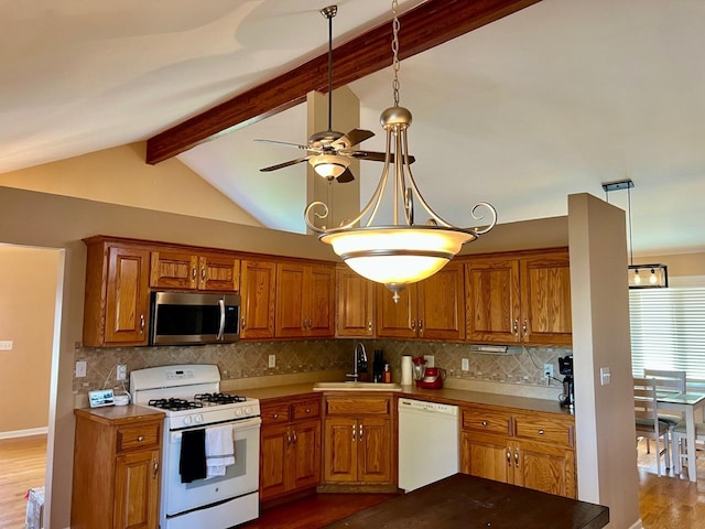 kitchen featuring white appliances, tasteful backsplash, light hardwood / wood-style flooring, and sink