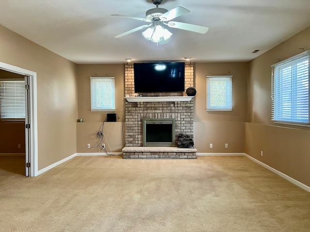 unfurnished living room featuring light carpet, a brick fireplace, and ceiling fan