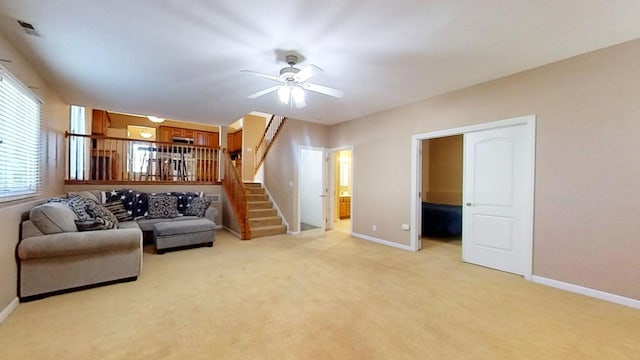 living room with light carpet and ceiling fan