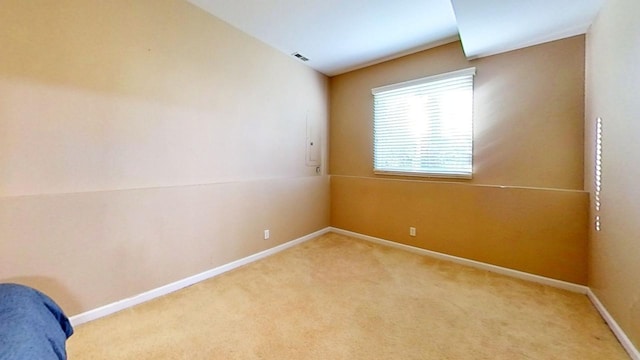 unfurnished bedroom with light colored carpet and lofted ceiling