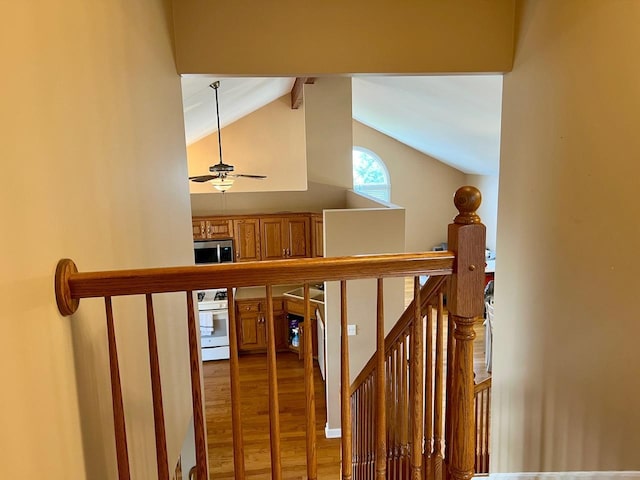 staircase featuring vaulted ceiling with beams, hardwood / wood-style flooring, and ceiling fan