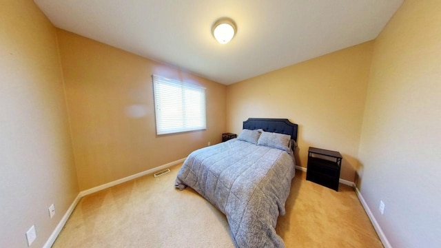 bedroom featuring light colored carpet