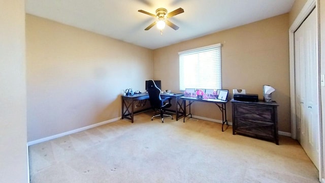 carpeted home office featuring ceiling fan