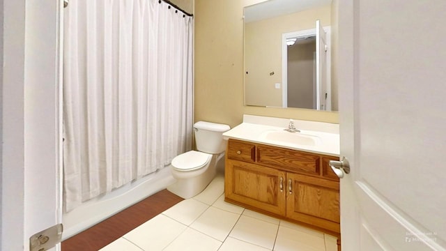 full bathroom with tile patterned floors, vanity, toilet, and shower / tub combo with curtain