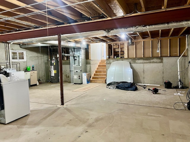 basement featuring heating unit, separate washer and dryer, and gas water heater