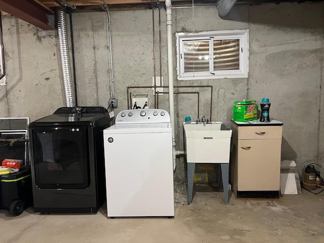 laundry area with separate washer and dryer and sink