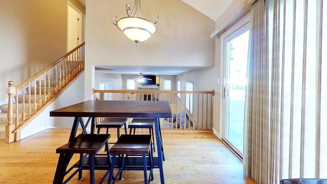 dining space featuring vaulted ceiling and light wood-type flooring