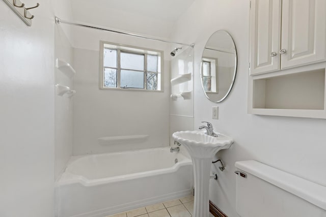 bathroom with tile patterned flooring, toilet, and bathtub / shower combination