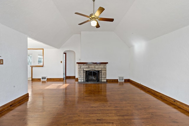 unfurnished living room with dark hardwood / wood-style floors, ceiling fan, lofted ceiling, and a fireplace