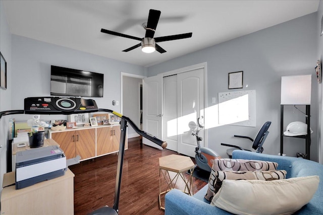 living room with dark hardwood / wood-style flooring and ceiling fan