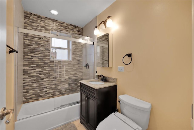 full bathroom with tile patterned floors, vanity, enclosed tub / shower combo, and toilet